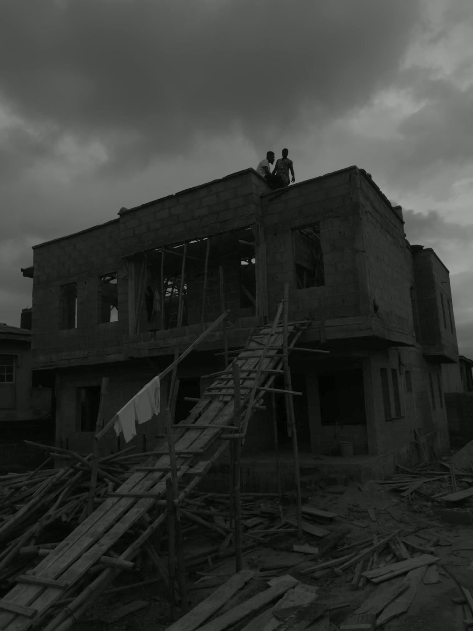 FAB's Associate blockwork building under construction at dusk, with the project team on the roof slab